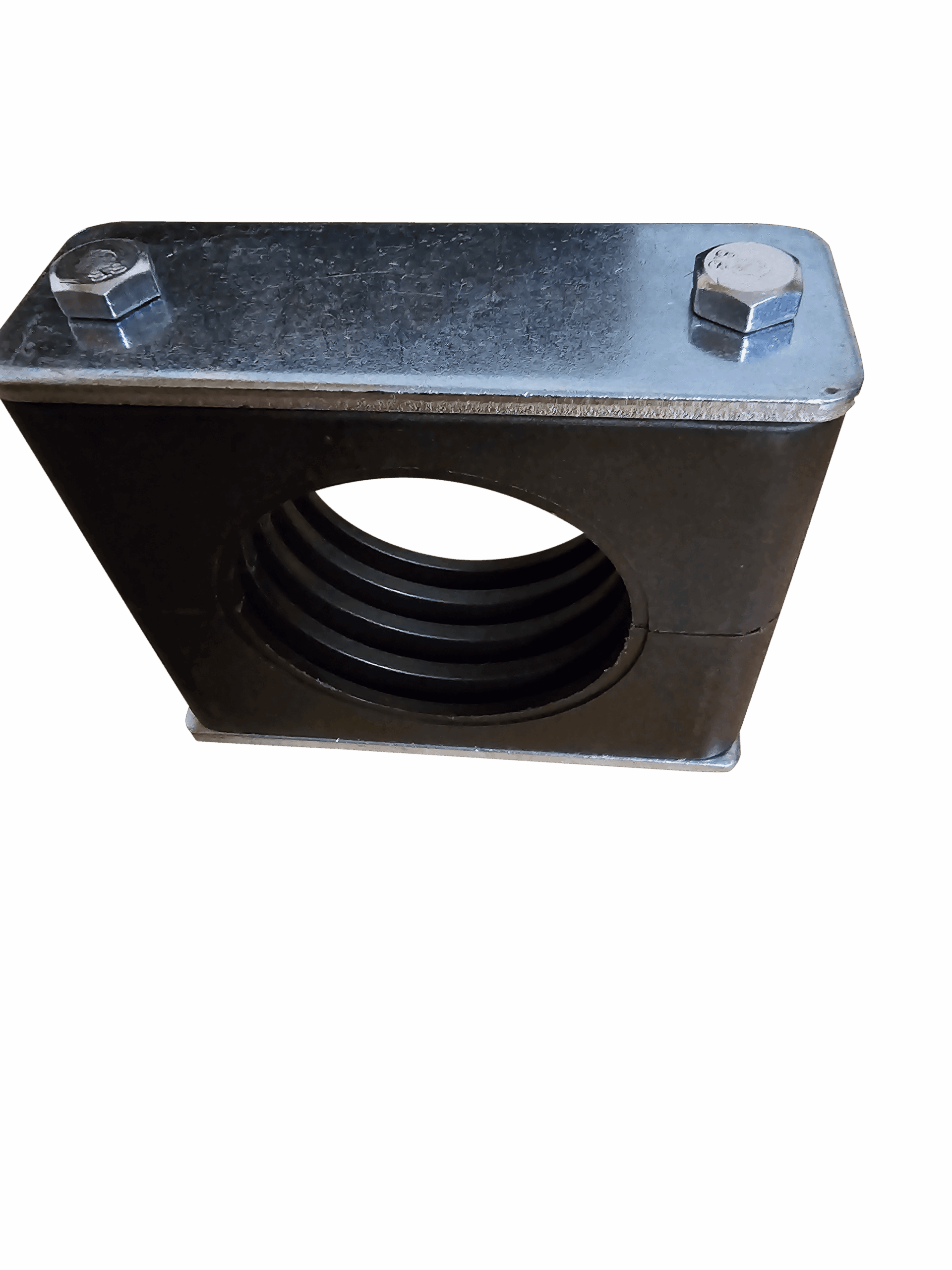 Close-up of a metal mounting bracket with two hex bolts on a steel surface against a red background
